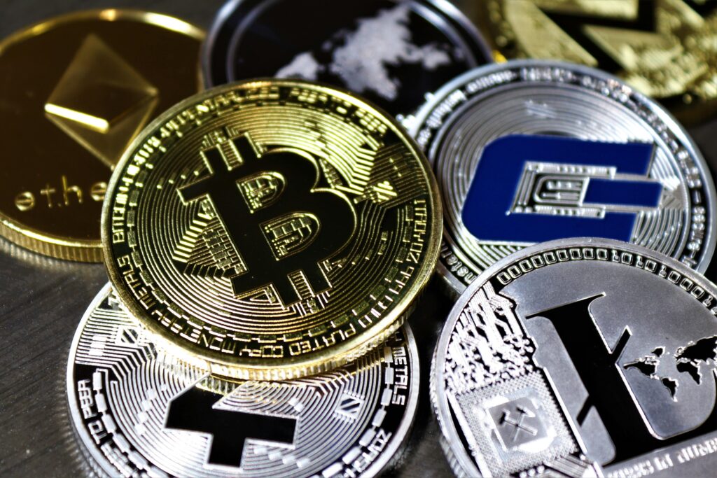 pexels-photo-5435844-5435844 Close-up view of assorted cryptocurrency coins featuring Bitcoin, Litecoin, and others, symbolizing digital finance.